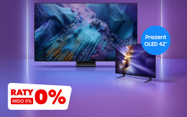 Dwa telewizory na fioletowym tle, większy z wyświetlanym obrazem w odcieniach niebieskiego i fioletowego oraz mniejszy z jasnym, dynamicznym wzorem. Na niebieskim okręgu widnieje napis: Prezent OLED 42 cale, a w lewym dolnym rogu znajduje się czerwony prostokąt z tekstem: Raty 0% RRSO 0%.